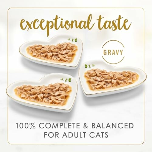 Three heart-shaped dishes with cat food in gravy.